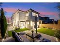 A beautiful home exterior shows a manicured backyard with an outdoor lounge area for relaxation at 2407 Ridgeline Wash St, Las Vegas, NV 89138