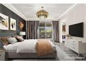 Relaxing main bedroom with balcony access, featuring neutral tones and stylish furnishings at 2407 Ridgeline Wash St, Las Vegas, NV 89138
