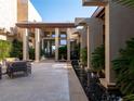 Elegant courtyard with sleek water features and fire bowls leading to the grand entrance at 28 Painted Feather Way, Las Vegas, NV 89135