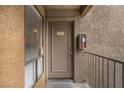 Condo entrance with taupe door, unit number 2034, and exterior fire extinguisher at 3151 Soaring Gulls Dr # 2034, Las Vegas, NV 89128