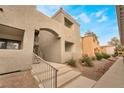 Stairway leads to condo entrance, featuring stucco exterior and low-maintenance landscape at 3151 Soaring Gulls Dr # 2034, Las Vegas, NV 89128