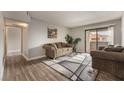 Living room with wood-look flooring, gray walls, and sliding glass door at 3151 Soaring Gulls Dr # 2034, Las Vegas, NV 89128