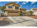 Two-story home featuring a two-car garage, well-manicured landscaping, and a charming exterior at 3381 Biscayne Bay Dr, Las Vegas, NV 89117