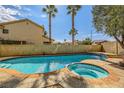 Backyard pool and spa area featuring a sparkling pool, raised spa, palm trees and lush landscaping at 3381 Biscayne Bay Dr, Las Vegas, NV 89117