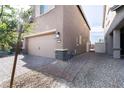 Home exterior featuring a two-car garage with a brick-paved driveway and side access gate at 3553 Judson Ave, Las Vegas, NV 89115