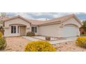 Street view of a single-story home with desert landscaping, with a front lawn of crushed gravel and small bushes at 3606 Altar Rock Ln, North Las Vegas, NV 89032