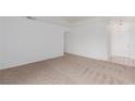 A bright, carpeted living room with white walls and a tiled entry at 3606 Altar Rock Ln, North Las Vegas, NV 89032