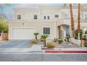 Elegant two-story home featuring a well-maintained front yard, a two-car garage, and beautiful desert landscaping at 5077 Thunder River Cir, Las Vegas, NV 89148