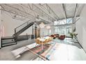 Bright and airy living area with industrial-style ceiling, modern furnishings, and plenty of natural light at 5077 Thunder River Cir, Las Vegas, NV 89148
