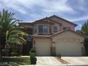 Lovely stucco house with a two-car garage, terracotta roof, and well-maintained landscaping at 5147 Villa Vecchio Ct, Las Vegas, NV 89141