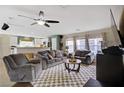 Comfortable living room with plush seating, ceiling fan, and open layout to the kitchen creates a cozy gathering space at 5213 Welch Valley Ave, Las Vegas, NV 89131