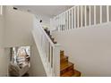 Staircase with wooden steps and white railing leads to the upper level, brightening up the home's interior at 5213 Welch Valley Ave, Las Vegas, NV 89131
