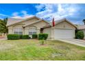 Inviting single-story home featuring a well-maintained lawn and attached garage at 5508 Lochmor Ave, Las Vegas, NV 89130