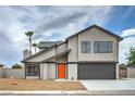 Charming two-story home with a well-maintained yard and a bright orange front door at 5629 Caladonia Ave, Las Vegas, NV 89110