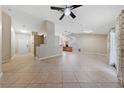 Spacious living room with tile flooring, neutral paint, and lots of natural light from sliding glass doors at 619 Ancient Mayan Dr, Henderson, NV 89015