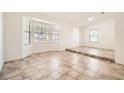 Bright living room with ceramic tile flooring, neutral paint, and a large bay window for ample natural light at 6225 Sadler Dr, Las Vegas, NV 89130