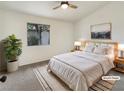 Relaxing bedroom with neutral colors, a ceiling fan, and a sunny window at 6412 Dallaswood Ln, Las Vegas, NV 89156