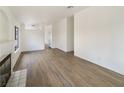 Spacious living room showcasing hardwood flooring and a cozy fireplace at 6412 Dallaswood Ln, Las Vegas, NV 89156