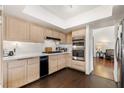 Well-lit kitchen with stainless steel appliances, ample counter space, and dark hardwood flooring at 680 Cervantes Dr, Henderson, NV 89014