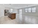Bright and airy living space with tile floors, stainless steel refrigerator, and modern finishes at 7006 Sylmar Ave, Las Vegas, NV 89113