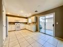 Bright kitchen with white cabinets, modern appliances, and sliding door to patio at 7173 Dravite Ct, Las Vegas, NV 89148