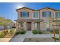 Attractive two-story townhome with stone accents and a cozy front porch at 7320 N Decatur Blvd # 5, Las Vegas, NV 89131