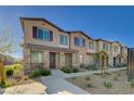 Attractive townhome with stone accents, covered entry, and well-maintained landscaping at 7320 N Decatur Blvd # 5, Las Vegas, NV 89131