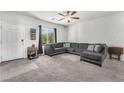 Comfortable living room with a large sectional sofa and plenty of natural light at 7323 Sunray Point St, North Las Vegas, NV 89084