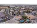 Aerial view of a neighborhood showcasing lush landscaping, community pools, and well-maintained homes at 810 Roaring Falls Ave, Henderson, NV 89052