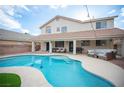 Backyard with a large pool, covered patio, and outdoor seating area perfect for entertaining at 810 Roaring Falls Ave, Henderson, NV 89052
