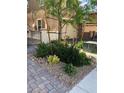 Landscaped front yard featuring trees, bushes and decorative rock at 8111 Switchback Run St, Las Vegas, NV 89166