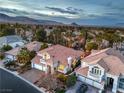 Expansive aerial view of a residential community with lush landscaping and mountain views at 8808 Rozetta Ct, Las Vegas, NV 89134