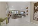 Open floorplan living room featuring tile floors, neutral decor and recessed lighting at 8992 Sparkling River Ct, Las Vegas, NV 89178