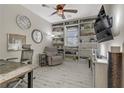 Home office featuring built-in shelving, ceiling fan and comfortable chair at 8992 Sparkling River Ct, Las Vegas, NV 89178