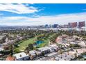 Scenic aerial view featuring a lush golf course, community homes, and the vibrant Las Vegas cityscape at 915 Vegas Valley Dr # 4, Las Vegas, NV 89109