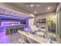 Inviting outdoor living space featuring a built-in bar with modern lighting and comfortable seating at 9928 Regency Square Ave, Las Vegas, NV 89148
