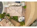 An aerial view of a well-maintained home with a backyard fire pit, outdoor seating, and desert landscaping at 1417 Brushback Ave, Henderson, NV 89074