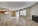 Spacious living room featuring modern flooring, neutral paint, and natural light from sliding glass door at 1575 W Warm Springs Rd # 413, Henderson, NV 89014