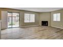 Cozy living room with wood flooring, fireplace, and a sliding glass door leading to a patio at 1575 W Warm Springs Rd # 413, Henderson, NV 89014