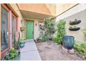 Inviting front porch featuring potted flowers and green front door at 1604 Danielle Rebecca Ave, North Las Vegas, NV 89086