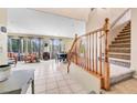 Inviting living room featuring tile flooring, many windows and staircase at 1604 Danielle Rebecca Ave, North Las Vegas, NV 89086