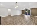 Open-concept living room with wood floors and lots of natural light at 234 Polaris Ridge Ave, Henderson, NV 89011
