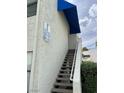Close-up of the entryway to a condo building with exterior stairs and a sign indicating unit numbers at 2637 Red Rock St # 202, Las Vegas, NV 89146