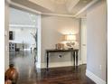 Hallway with dark floors, neutral walls, and dark wood console table with lamp at 2777 Paradise Rd # 1701, Las Vegas, NV 89109