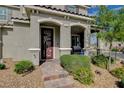 Welcoming front entrance with a decorative door, covered porch, and landscaped surroundings at 2853 Cabrillo Terrace St, Henderson, NV 89044