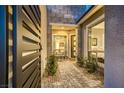 Charming courtyard with stone pathway, seating, plants and privacy gate welcomes you to the home at 2910 Raywood Ash Dr, Las Vegas, NV 89138
