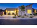 Modern home boasts a clean design, three-car garage, xeriscaping, and tasteful stone accents at 2910 Raywood Ash Dr, Las Vegas, NV 89138