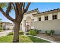 Charming single-story home featuring a stucco exterior, decorative iron gate, and mature landscaping at 2964 Via Della Amore, Henderson, NV 89052