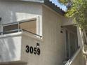 Close-up view of a condo exterior featuring a balcony, private entrance, and modern lighting fixtures at 3059 Key Largo Dr # 203, Las Vegas, NV 89120