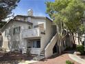Charming condo with private balcony, inviting front entrance, and beautiful landscaped yard at 3059 Key Largo Dr # 203, Las Vegas, NV 89120